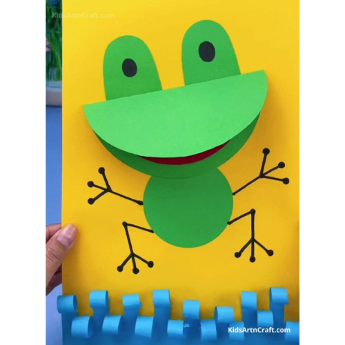green silly little frog on yellow paper