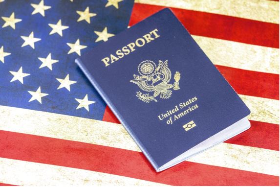 American flag with U.S. passport laid over the top