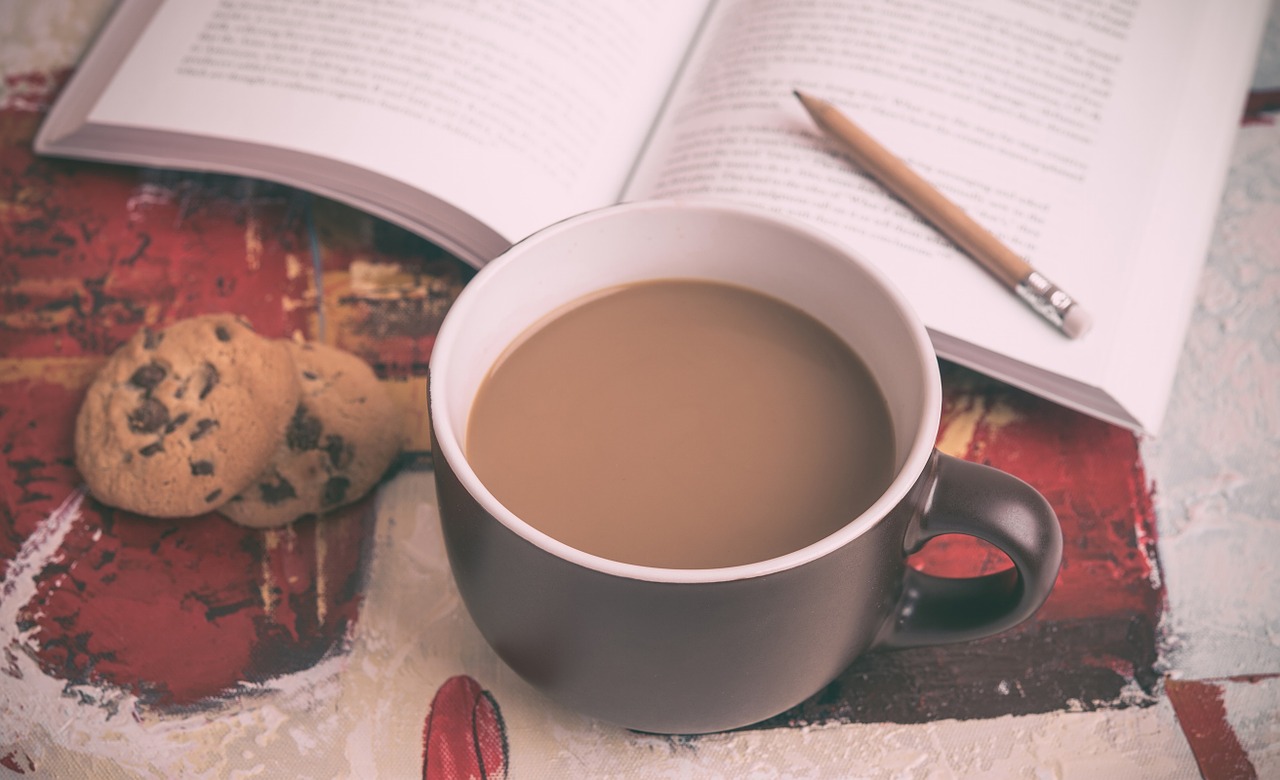 Book with coffee and cookies