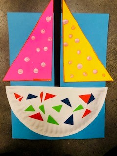 An example of a previous craft. A paper plate sailboat on construction paper.