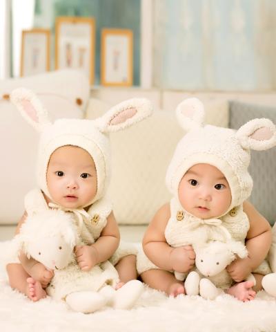 Two babies in bunny suits.
