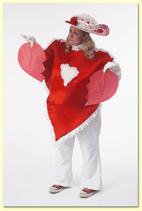 A woman wearing a heart costume holding a broken heart.