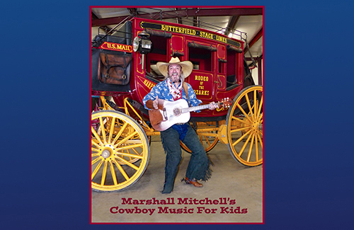 The Singing Cowboy is standing in front of a stagecoach.