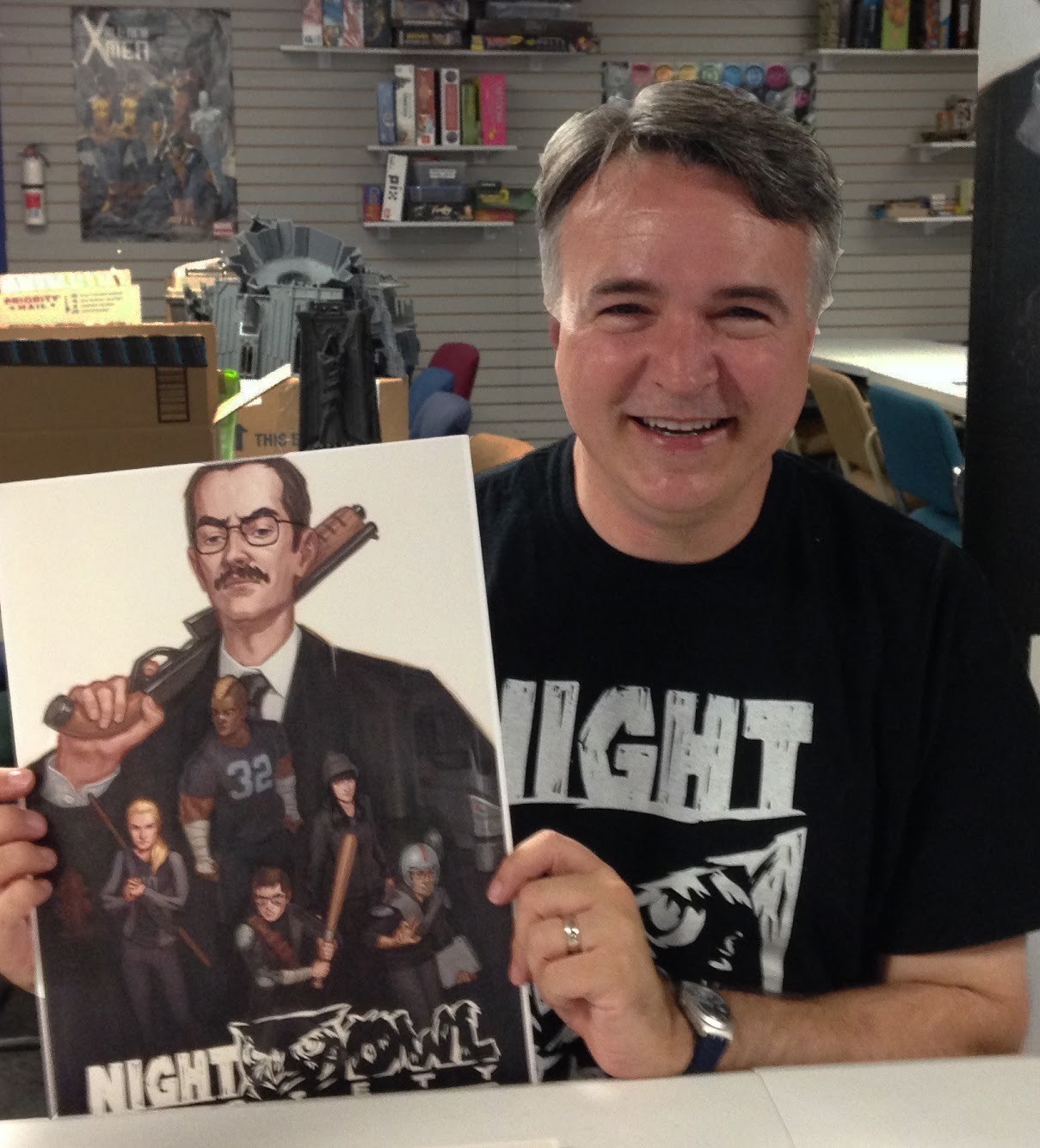 image of author James Venhaus holding one of his graphic novels
