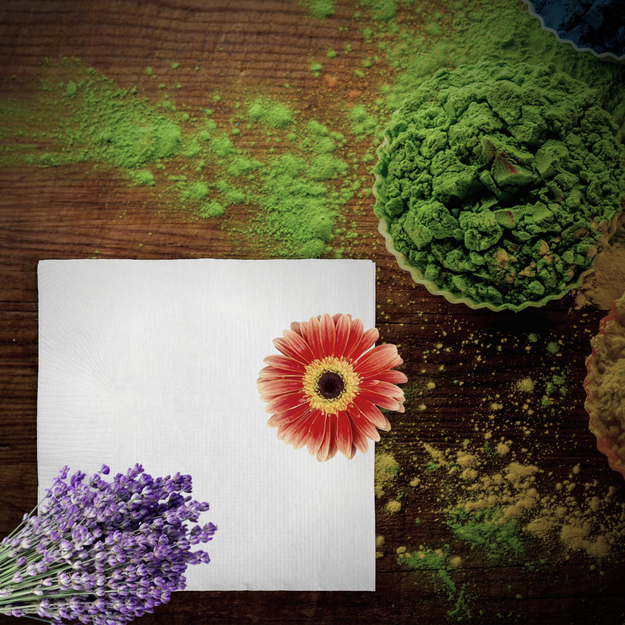 Flowers, pigments, and a napkin on a table