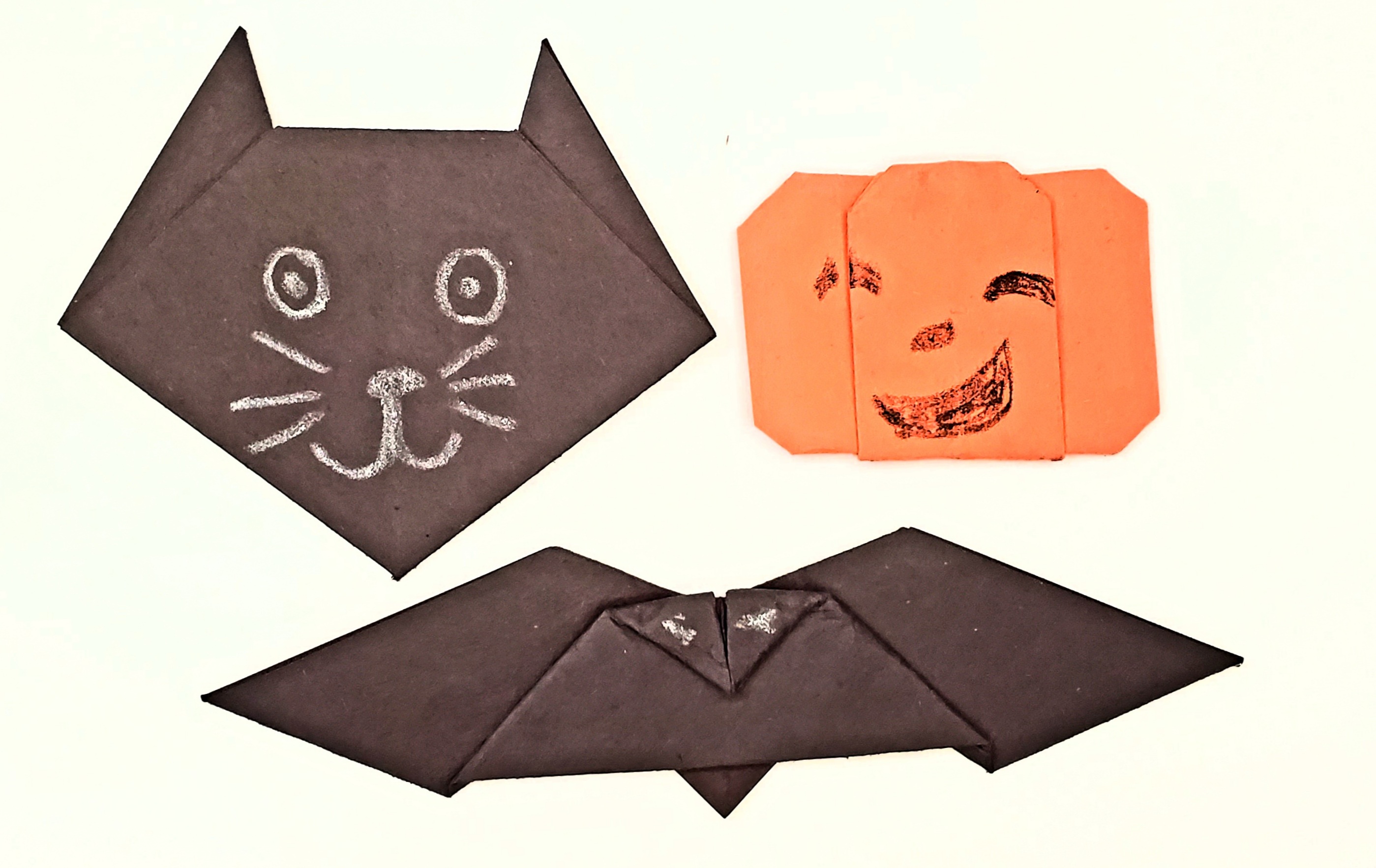 Halloween origami of a cat face, pumpkin/Jack-o-Lantern and bat