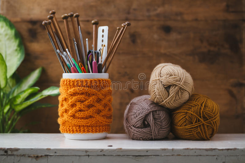 Crochet hooks and knitting needles with yarn