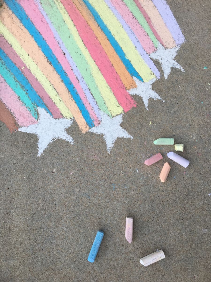 A rainbow in chalk on concrete.