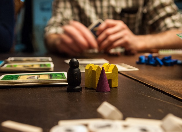 Board Game Pieces with Person in the Background