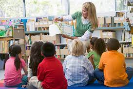 lady reading book to children