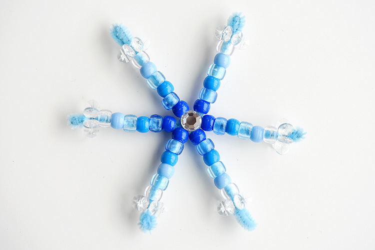 blue pipe cleaner in snowflake shape with blue and white beads