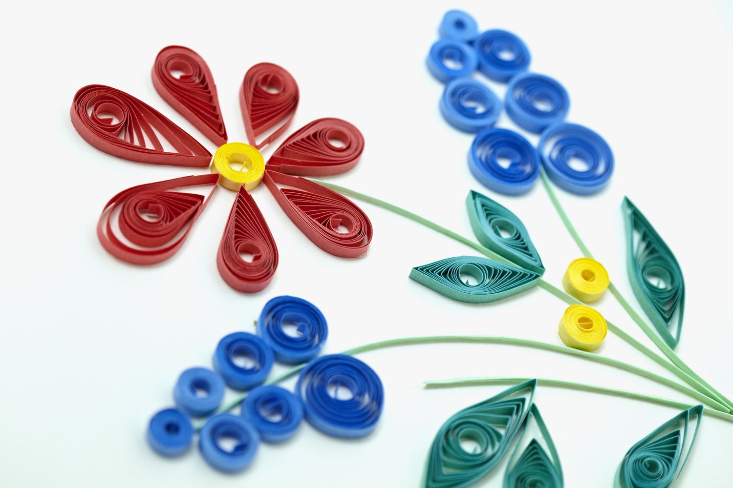 Paper quilling is the art of cutting paper into long thin strips, rolling and pinching the pieces into different shapes, and then gluing the shapes together to form decorative art. 