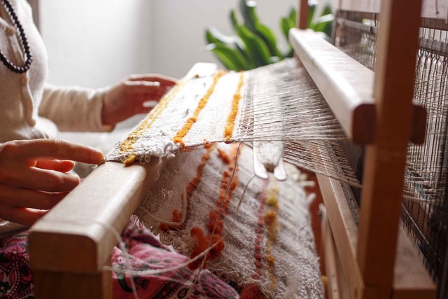Woman Weaving White and Yellow Fabric on a Loom