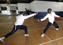 2 people fencing match- with equipment