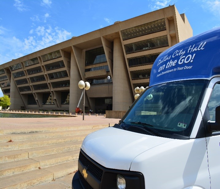 Front of City Hall on the GO! vehicle with Dallas City Hall in background
