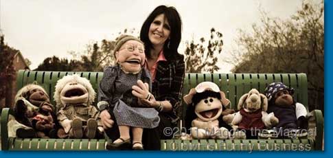 Maricela sitting on a park bench with her puppet friends. 