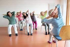 group of people doing yoga poses with option to sit in chair