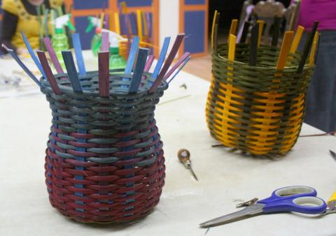 Two small, colorful woven baskets sitting on a table