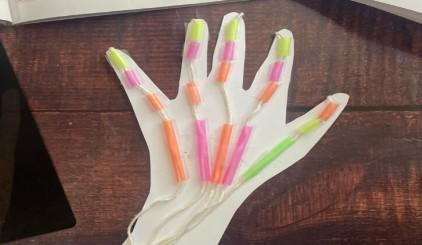 articulated skeleton hand made from straws, yarn, and paper