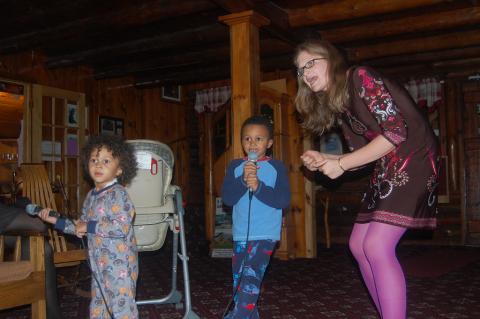 A family enjoys a round of karaoke.