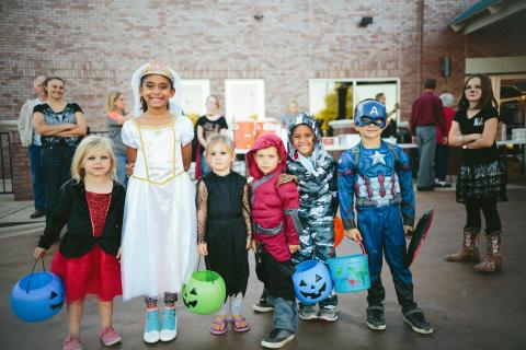 line of children in halloween costumes