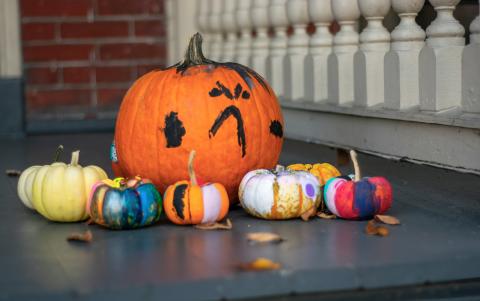 painted pumpkins on a porch