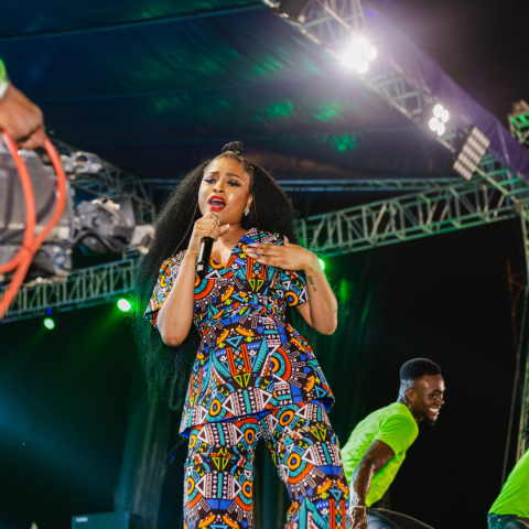 female singer on stage in front of camera