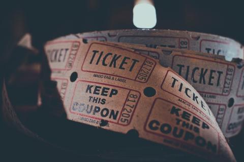 image of a reel of admission tickets with black background