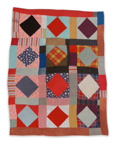 A colorful quilt made up of various patterned and solid fabrics, arranged in a grid.