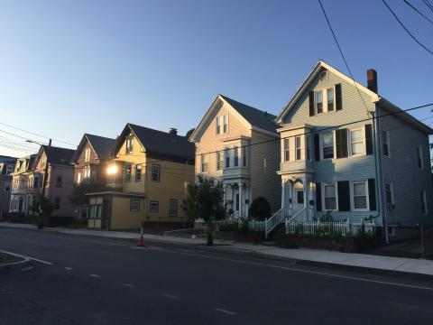 row of houses half in shadow as sun sets