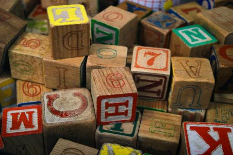 wooden alphabet blocks in a jumbled pile