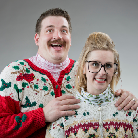 To silly looking people posed for a Christmas photo