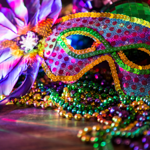 Stylized mardi gras mask and beads 