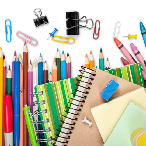 Colored pencils, notebooks and other school supplies on a white background