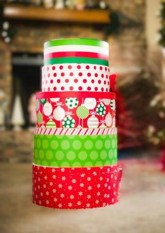 pile of holiday paper in red, greens and white in stripes and polka-dots