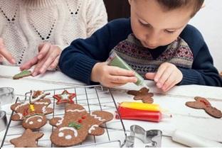 kid decorating gingerbread cookie