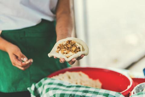 person making pupusas