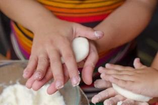 kid making arepas
