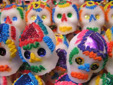 White candy skulls made of sugar are decorated with colorful icing.
