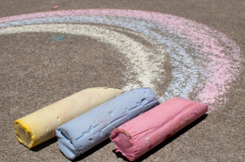 Chalk drawing a rainbow on a sidewalk