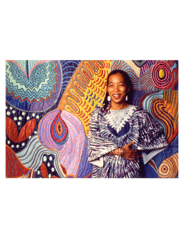 Picture of Artist Pacita Abad in front of her art