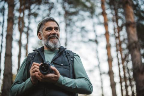 man holding camera in nature