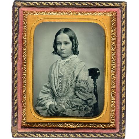Old photo of a woman in an ornate frame