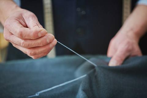 person hand sewing