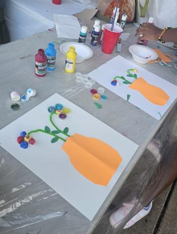 table with craft supplies and the beginning of two flower vase art projects