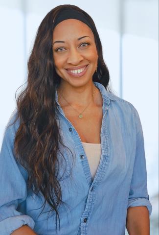 young woman in a blue jean shirt with long brown hair