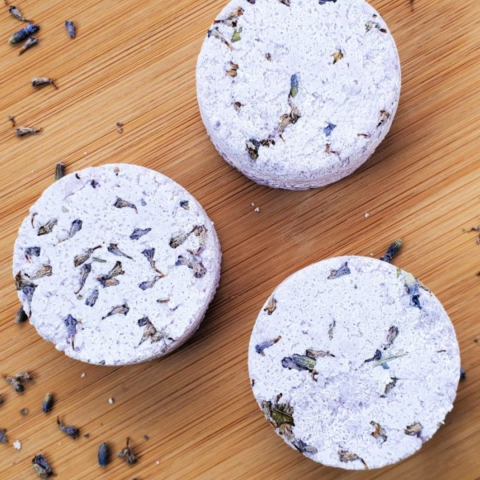 three purple circular steamers on wood