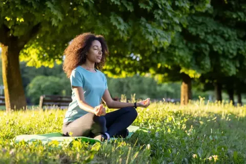 women meditating in nature