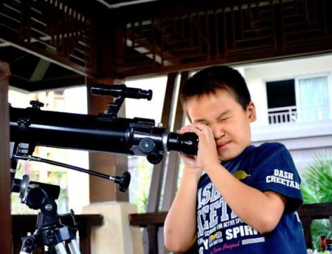 Boy looking through telescope