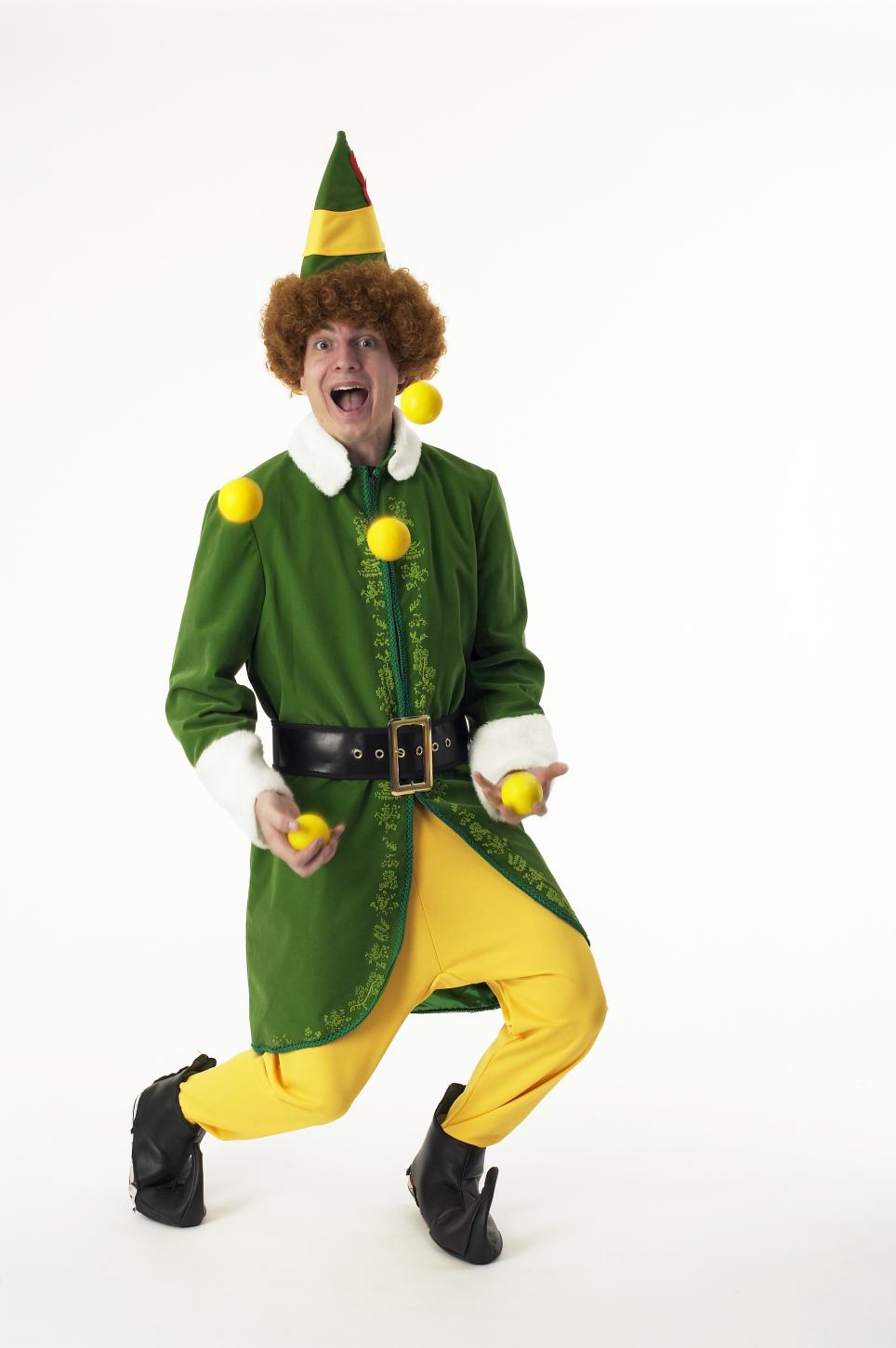 A male juggler wearing an elf outfit.